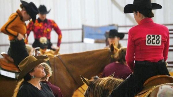 a group of people in cowchild hats riding horses